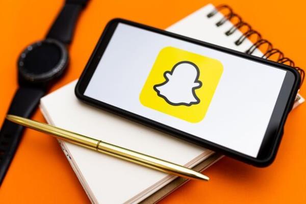 In this photo illustration a Snapchat logo seen displayed on...