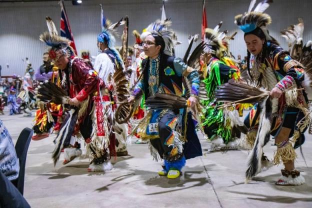 Dancers enter the powwow arena for Grand Entry.