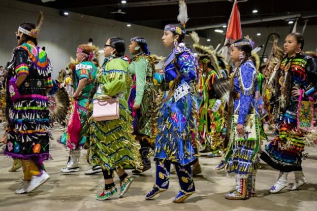 Dancers enter the powwow arena for Grand Entry.