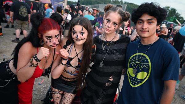 A group of fans pose together at the 2023 Gathering of the Juggalos