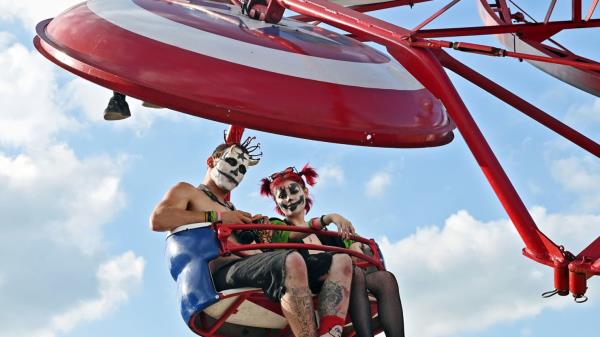 Two fans pose together at the 2023 Gathering of the Juggalos