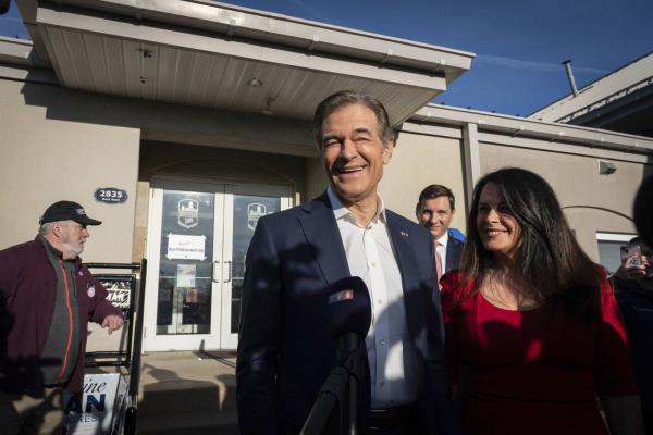 Dr. Mehmet Oz and his wife Lisa Oz exit Bryn Athyn Borough Hall after voting in Huntingdon Valley, Pa., Tuesday, Nov. 8, 2022. 