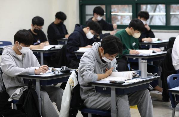 South Korean students take their College Scholastic Ability Test at a school in Seoul in November 2022. | POOL / VIA REUTERS