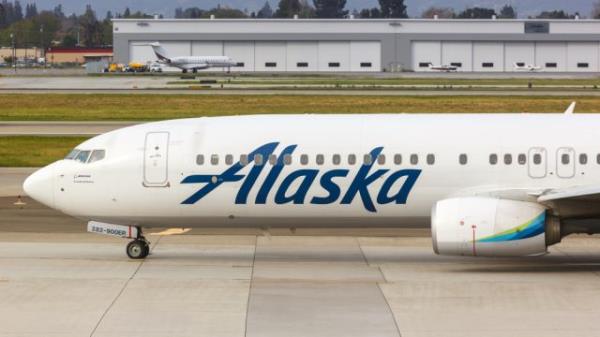 An Alaska Airlines plane sitting on the runway