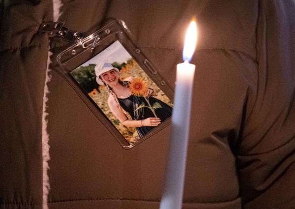 A photo of Abby Zwerner is pinned to a coat during a vigil for Zwerner, the teacher shot by a 6-year-old student at Richneck Elementary, in front of the Newport News Public Schools Administration Building on Jan. 9, 2023. 