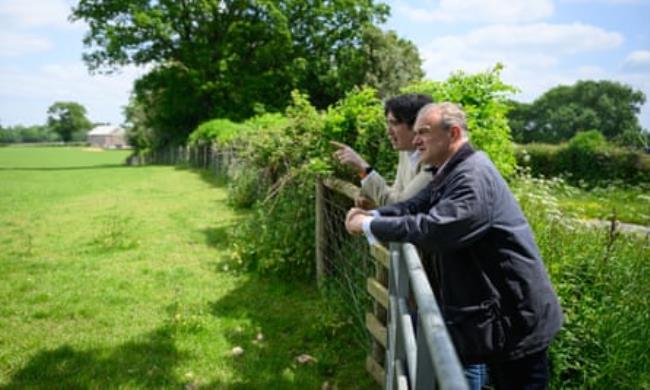 Ed Davey (right) speaking to Paul Follows, a prospective Lib Dem candidate, at the planned drilling site in Dunsfold, in the Surrey Hills