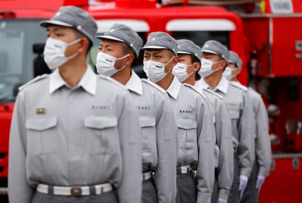 Tokyo Fire Department ambulance unit perso<em></em>nnel take part in a review in January 2022. 