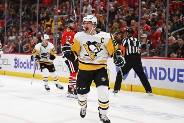 A hockey player with a mustache celebrates after scoring a goal.