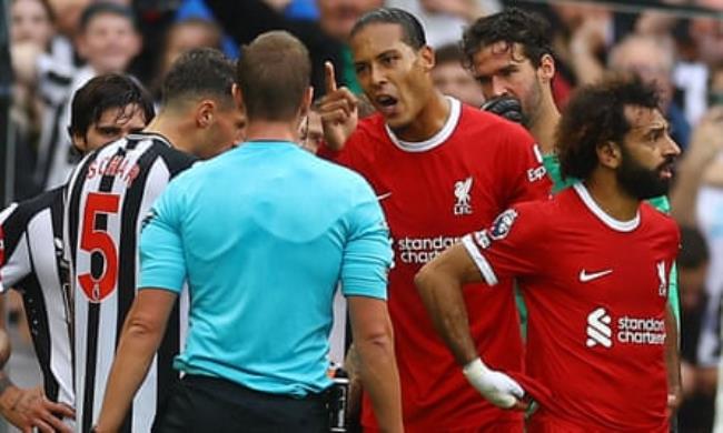 Liverpool’s Virgil van Dijk reacts after he is shown a red card by referee John Brooks