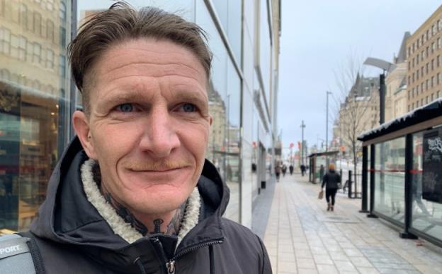 Gabriel White waits for an R1 replacement bus at platform B outside the Rideau Centre on Jan. 7, 2022.