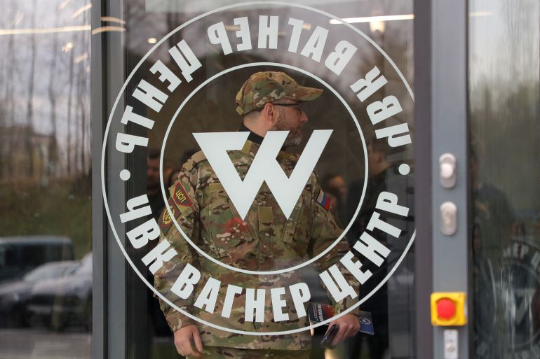 A man wearing a camouflage uniform walks out of PMC Wagner Centre, which is a project implemented by the businessman and founder of the Wagner private military group Yevgeny Prigozhin, during the official opening of the office block in Saint Petersburg, Russia, November 4, 2022.