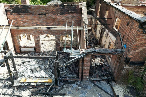 The burnt out remains of The Crooked House pub near Dudley before its unauthorised demolition, which is now under investigation.