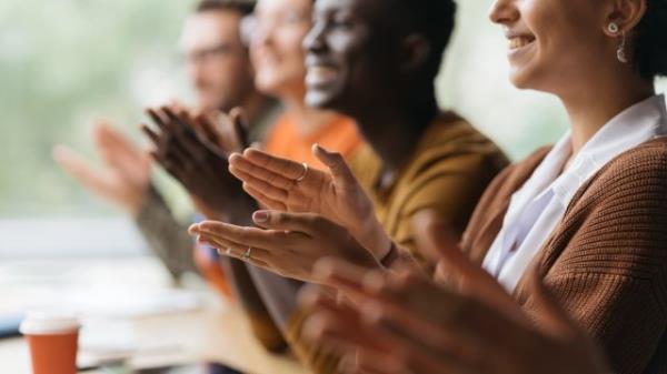 group of business people applauding together.