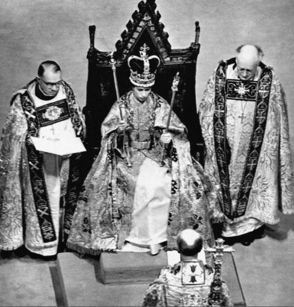 In 1953, the Coro<em></em>nation of Queen Elizabeth II took place at Westminster Abbey. Her Majesty is pictured during the Crowning Ceremony, seated on the Coro<em></em>nation Chair, wearing the St. Edward Crown and carrying the Sovereign's Sceptre and Rod.