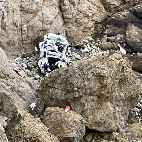 This image from video provided by San Mateo County Sheriff's Office shows a Tesla vehicle that plunged off a Northern California cliff along the Pacific Coast Highway, Monday, Jan. 2, 2023, near an area known as Devil's Slide, leaving four people in critical condition, a fire official said. 