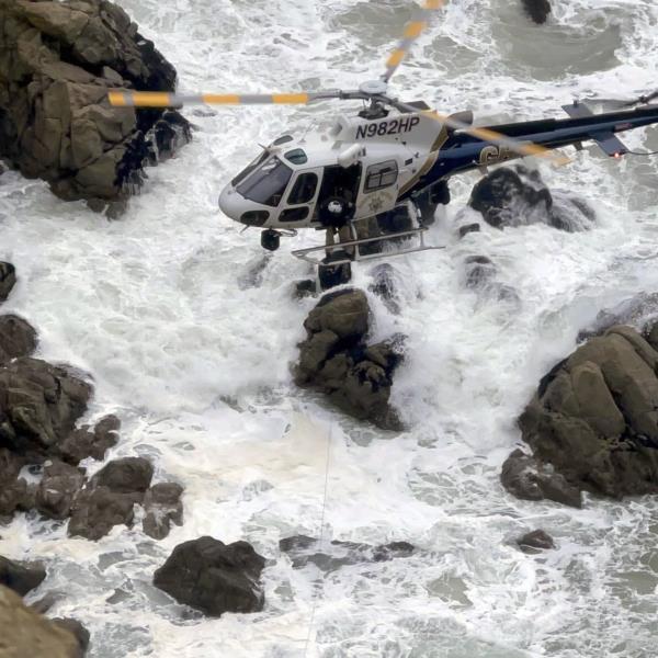 This image from video provided by San Mateo County Sheriff's Office shows a helicopter rescue after a Tesla plunged off a Northern California cliff along the Pacific Coast Highway, Monday, Jan. 2, 2023, near an area known as Devil's Slide, leaving four people in critical condition, a fire official said. 