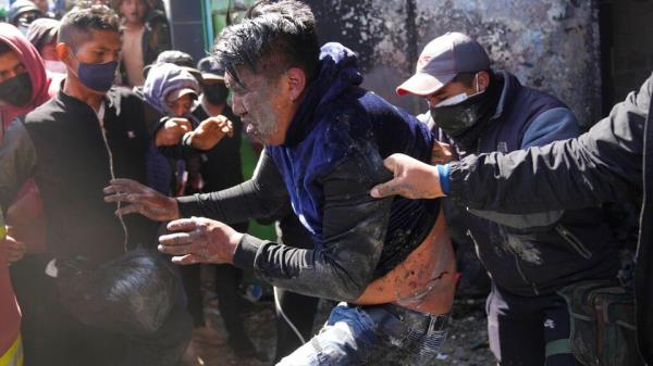 Anti-government coca farmers beat another coca grower who they say is a government supporter.