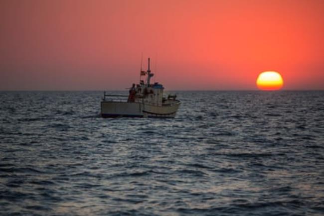 Fishing boat on the water at sunset