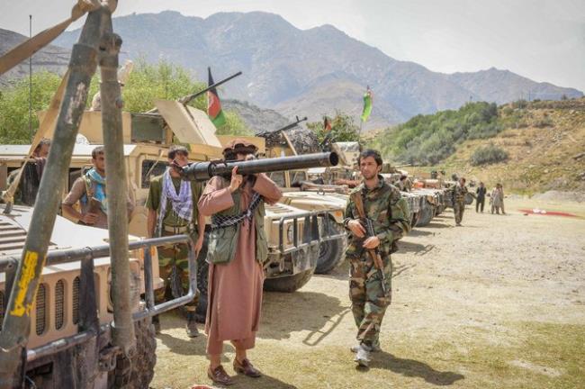 Afghan armed men supporting the Afghan security forces against the Taliban stand with their weapons and Humvee vehicles at Parakh area in Bazarak, Panjshir province on August 19, 2021. (AFP)