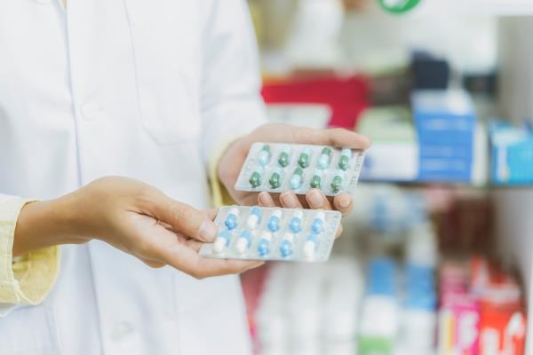 Close up hand of Pharmacist holding medicine