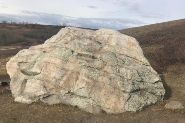 A rock sits in a park.