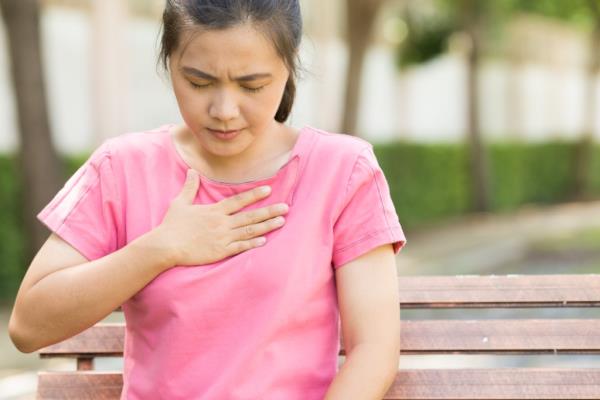 woman with hand over heart, ways you're damaging teeth