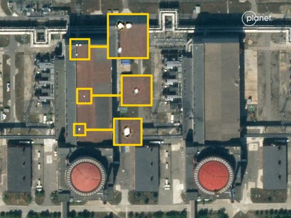 Five unidentified shapes can be see on top of Reactor 4 in this image from Planet Labs