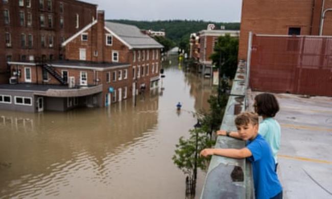 children overlooking flooded street