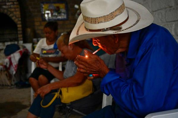 A man smokes in the community of Agujita, Sabinas Municipality, Coahuila State, Mexico, on August 15, 2022.