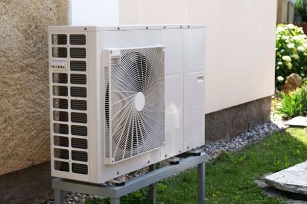 Heat pump or air co<em></em>nditioning outdoor unit in modern house of future using green electric energy, heat pump - efficient source of heat