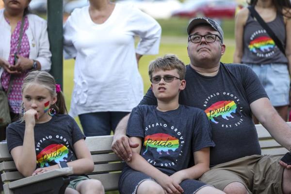 Mark Silgalis, right, and children Audrey and Xander Silgalis, watch the Pride flag-raising ceremony on June 1, 2023, in Buffalo Grove. 