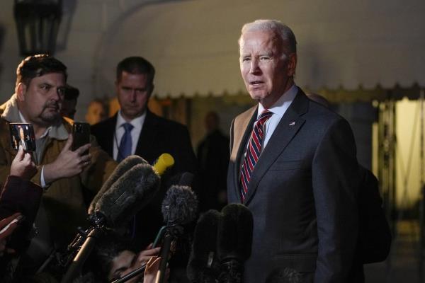 President Joe Biden speaks to reporters before boarding Marine One on the South Lawn of the White House in Washington, Friday, Jan. 27, 2023, as he heads to Camp David.